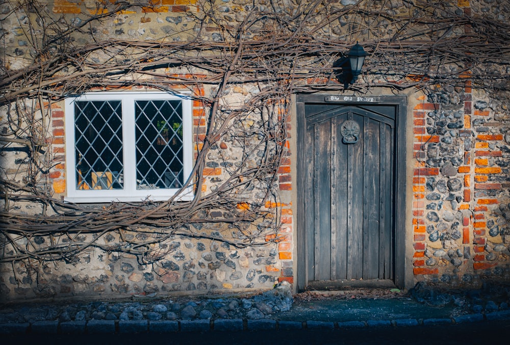 a brick building with a wooden door and window