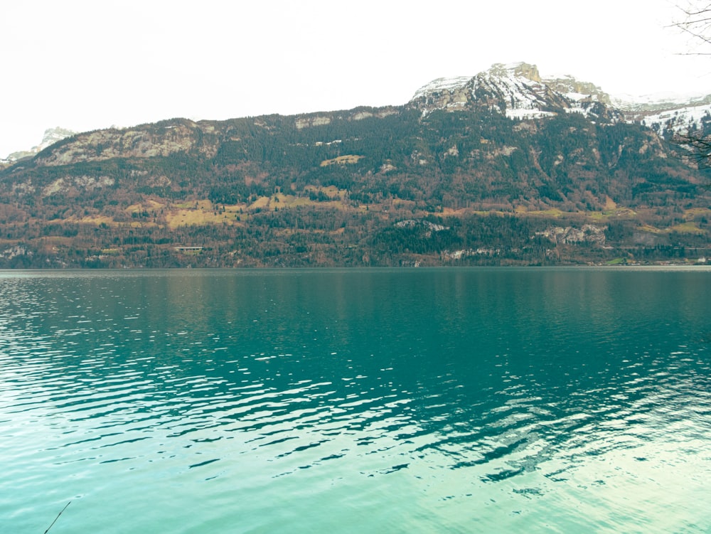 a body of water with a mountain in the background