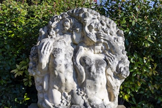a statue of a woman holding a man's head