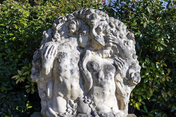 a statue of a woman holding a man's head