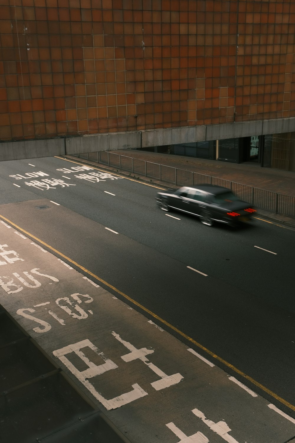 a car driving down a street next to a building