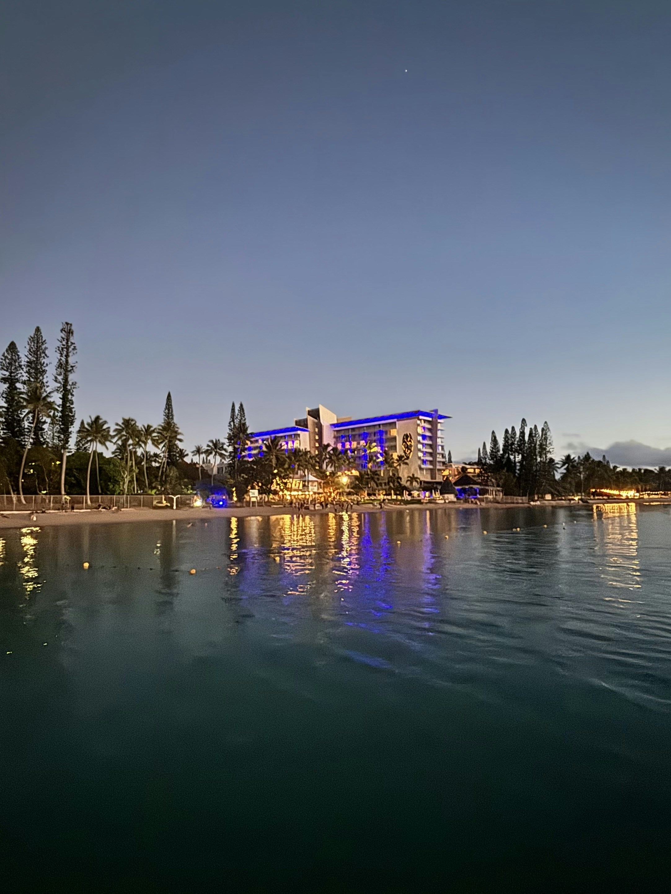 a large body of water with a building in the background