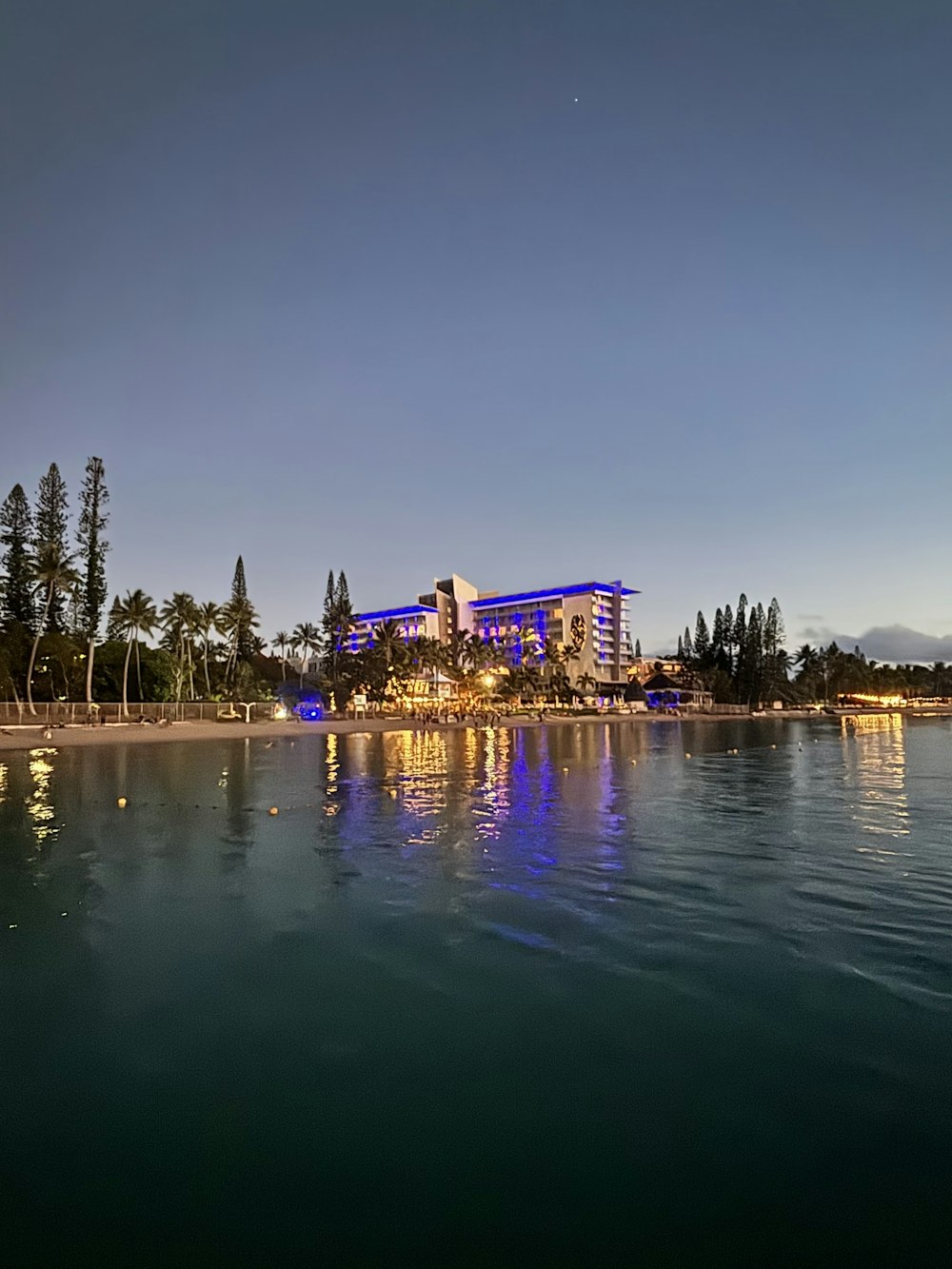 a large body of water with a building in the background