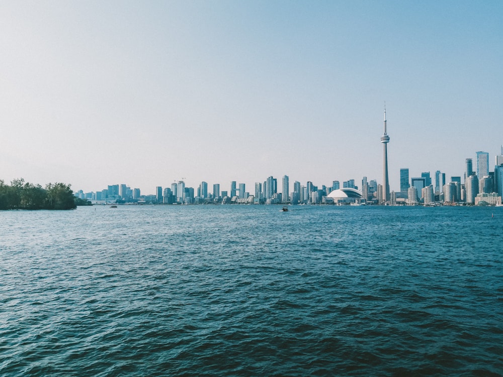 a large body of water with a city in the background