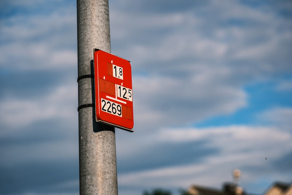 a red street sign on a metal pole