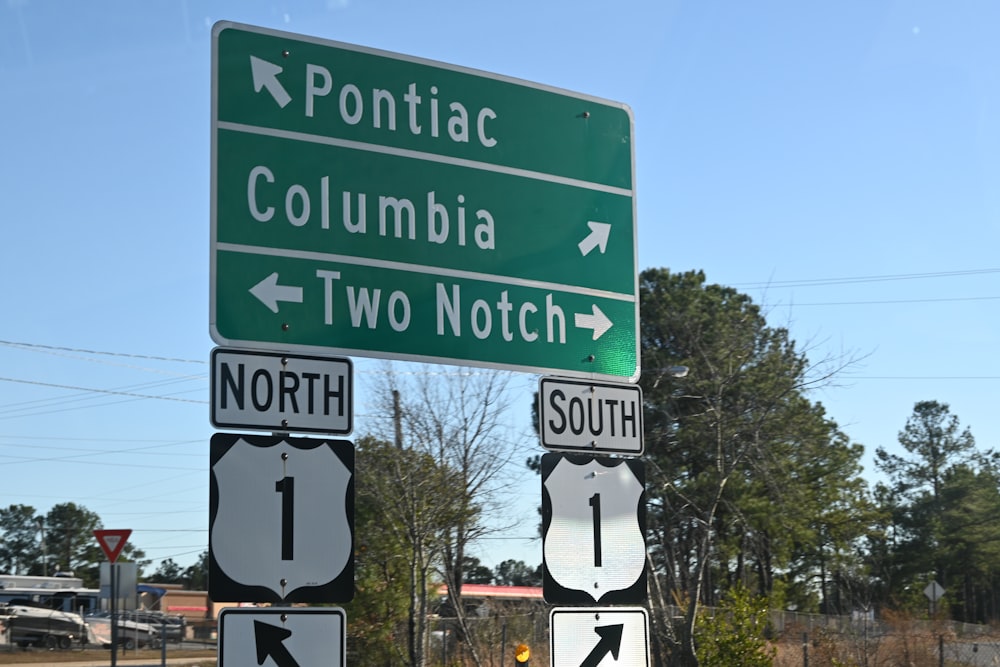 a couple of street signs sitting on the side of a road