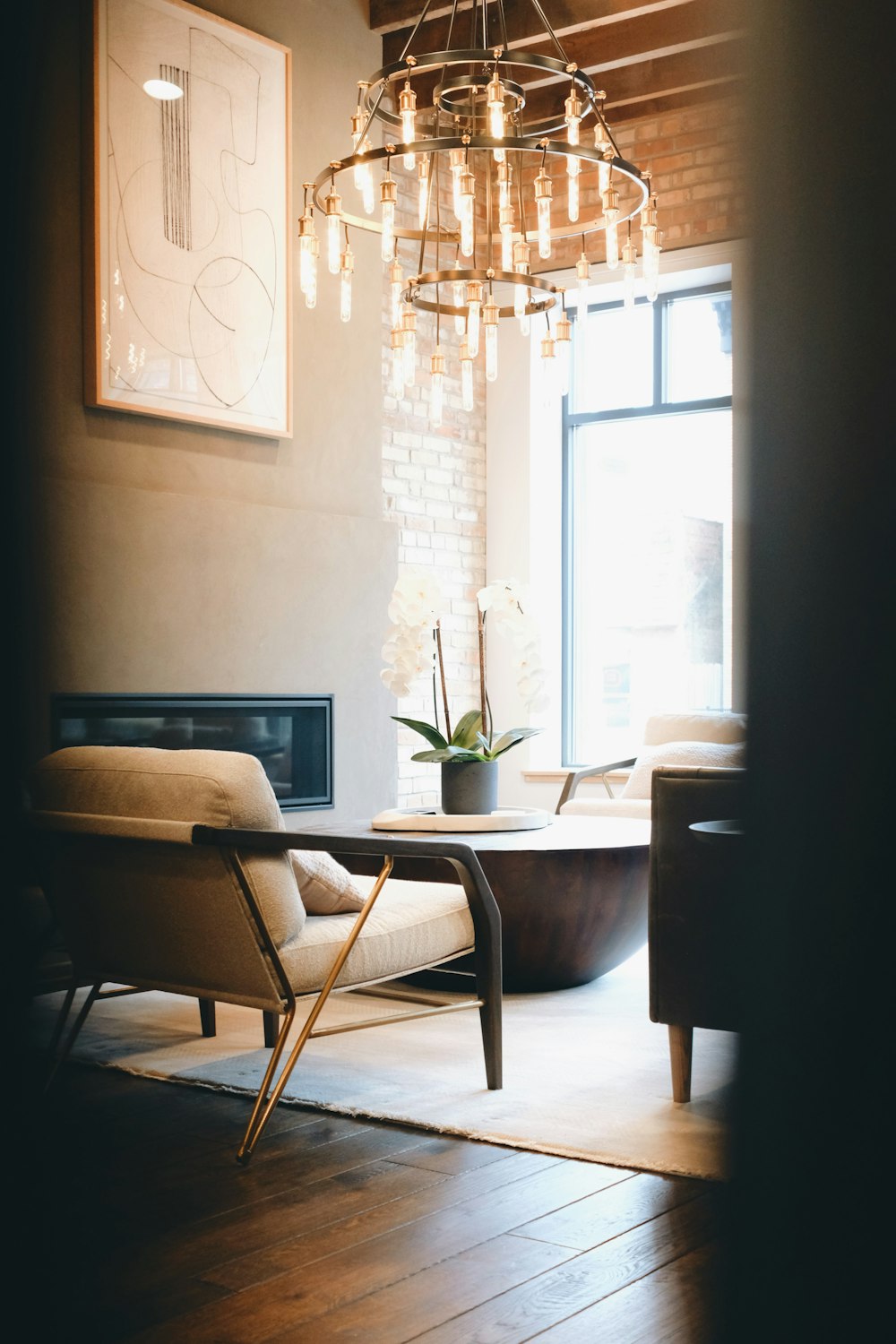 a living room with a chandelier hanging from the ceiling