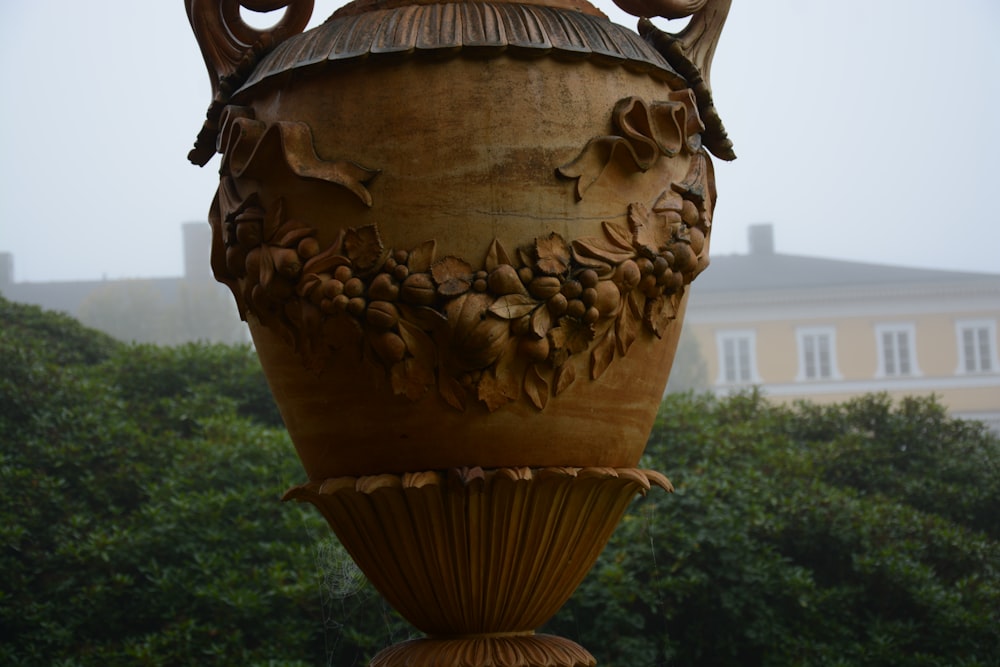 a large vase sitting in front of a building