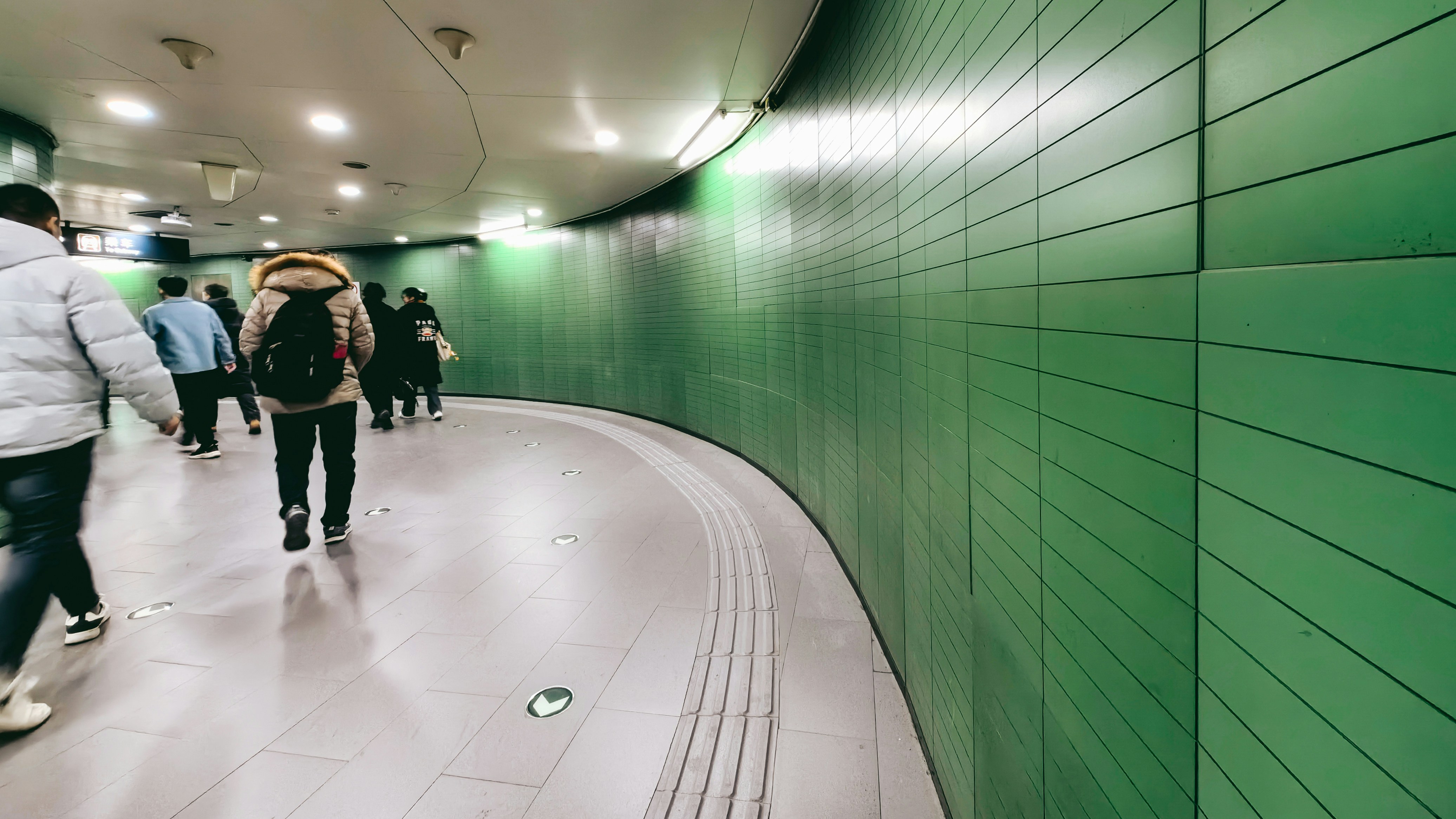 a group of people walking through a tunnel