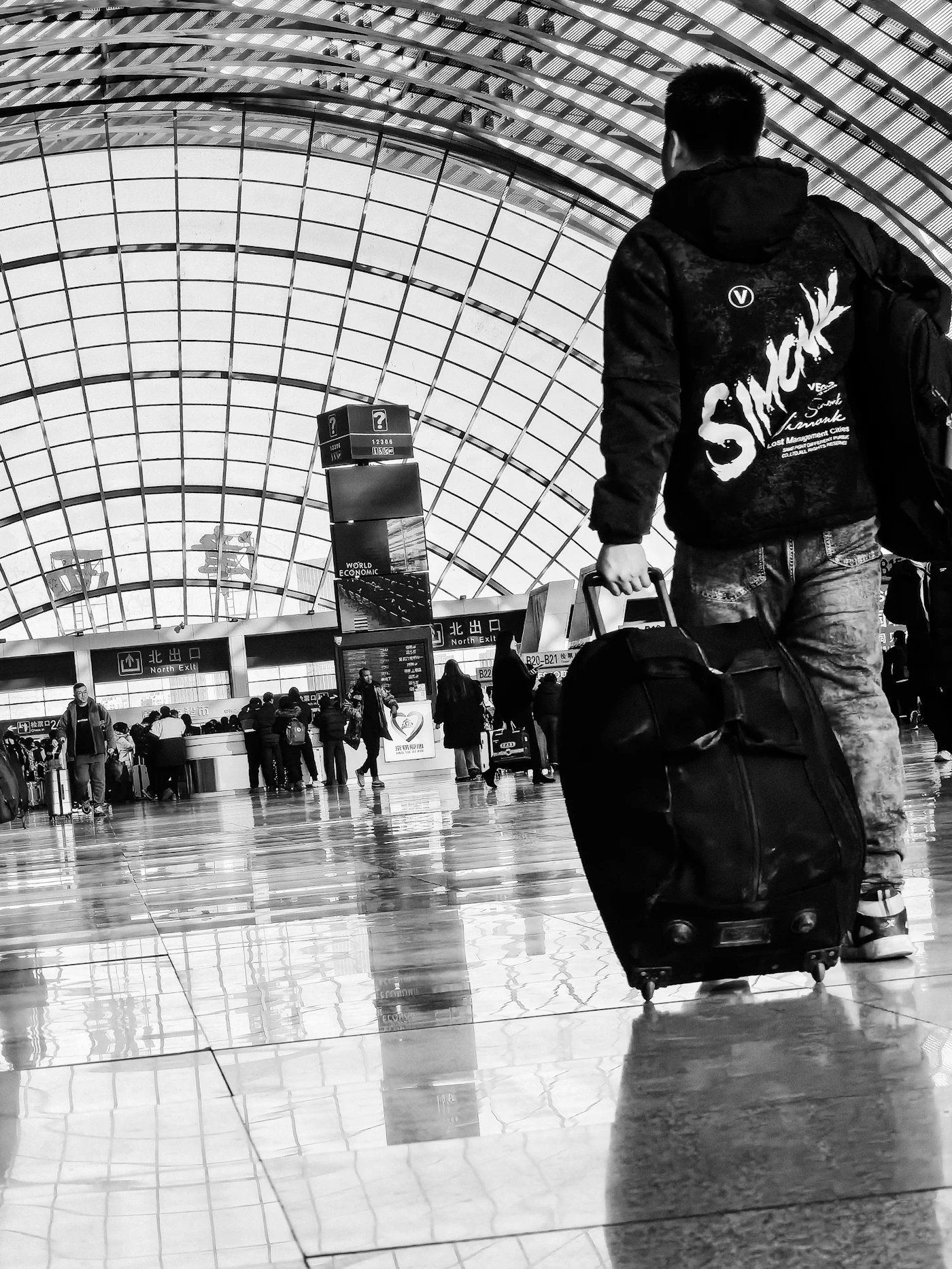Traveler pulling luggage through an airport terminal