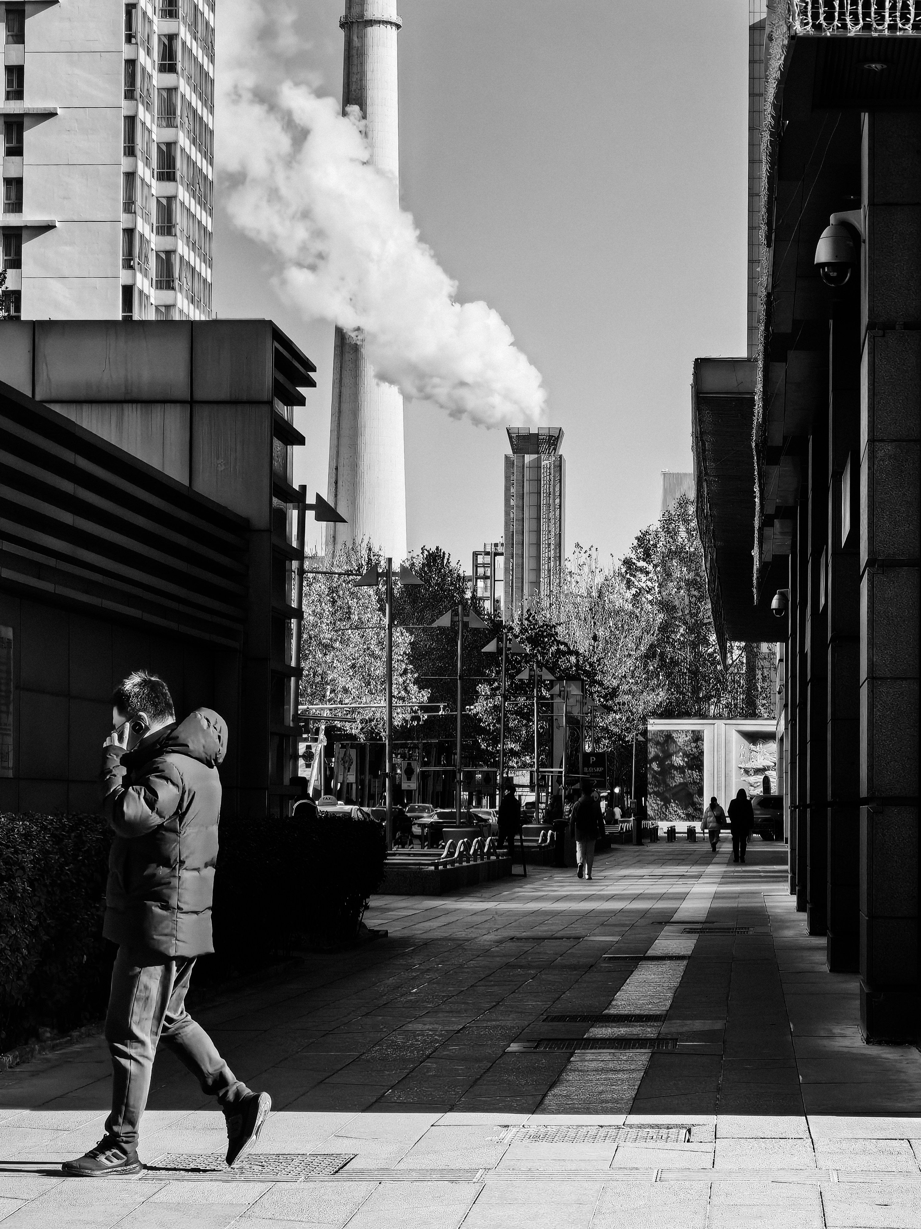 a man walking down a street while smoking a cigarette