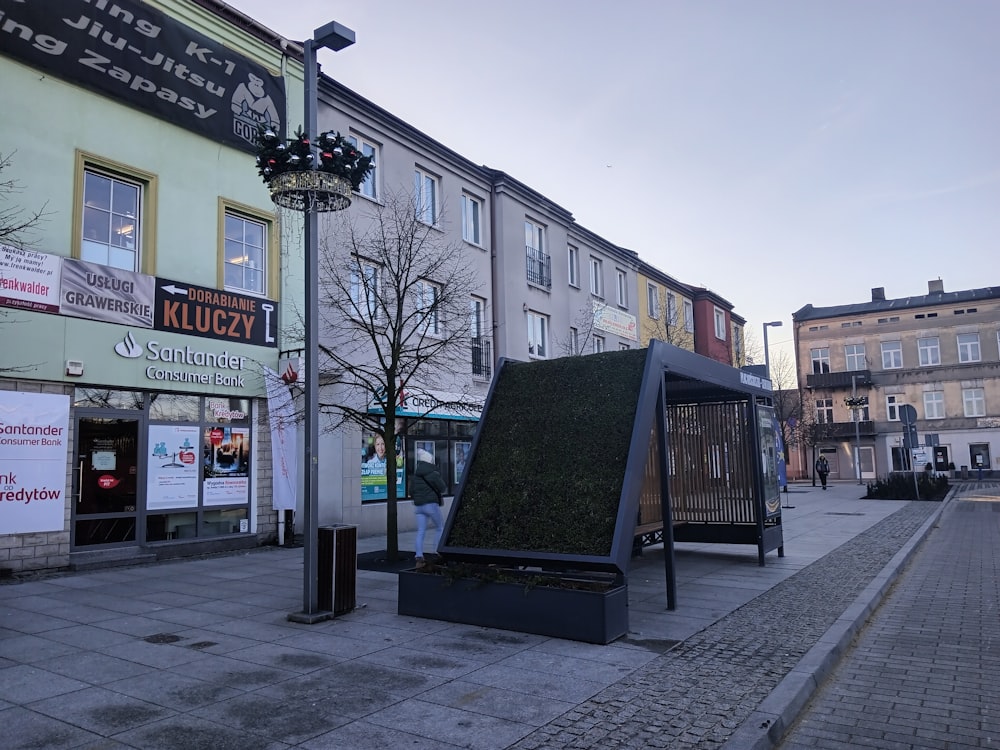 a street corner with a sculpture on the side of it