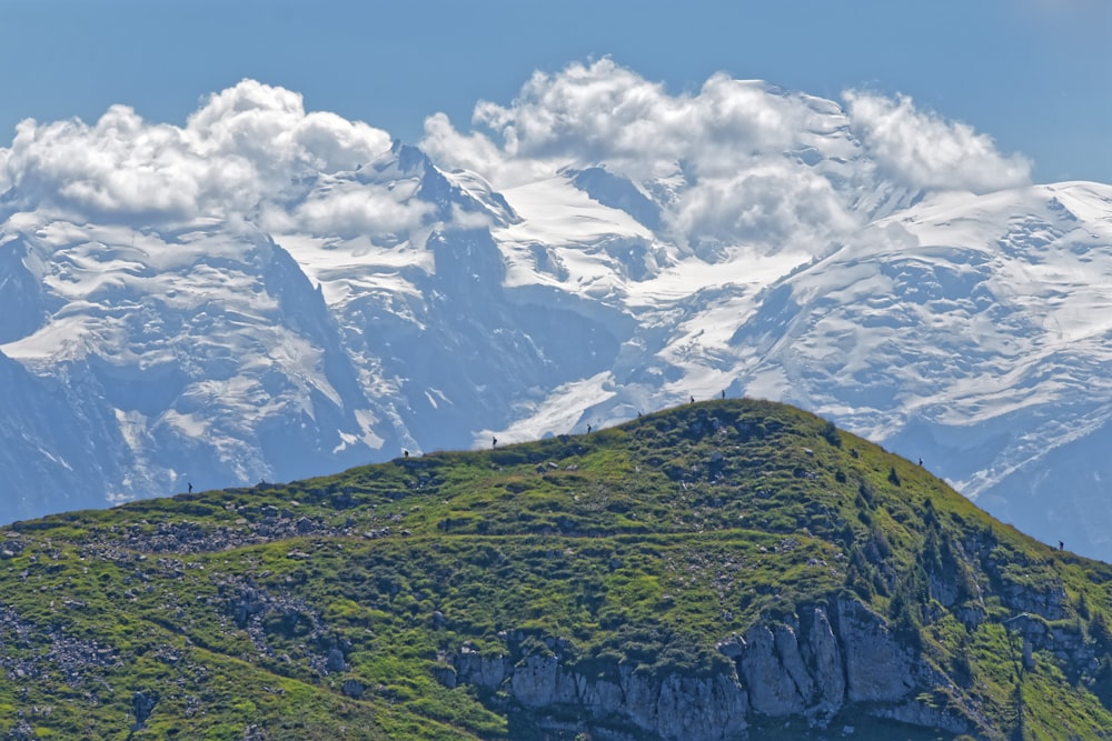 a mountain range with snow capped mountains in the background