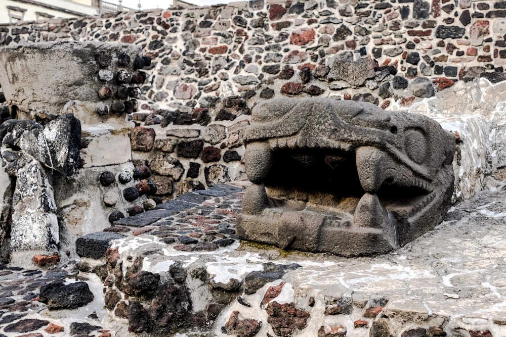 a stone structure with a face carved into it