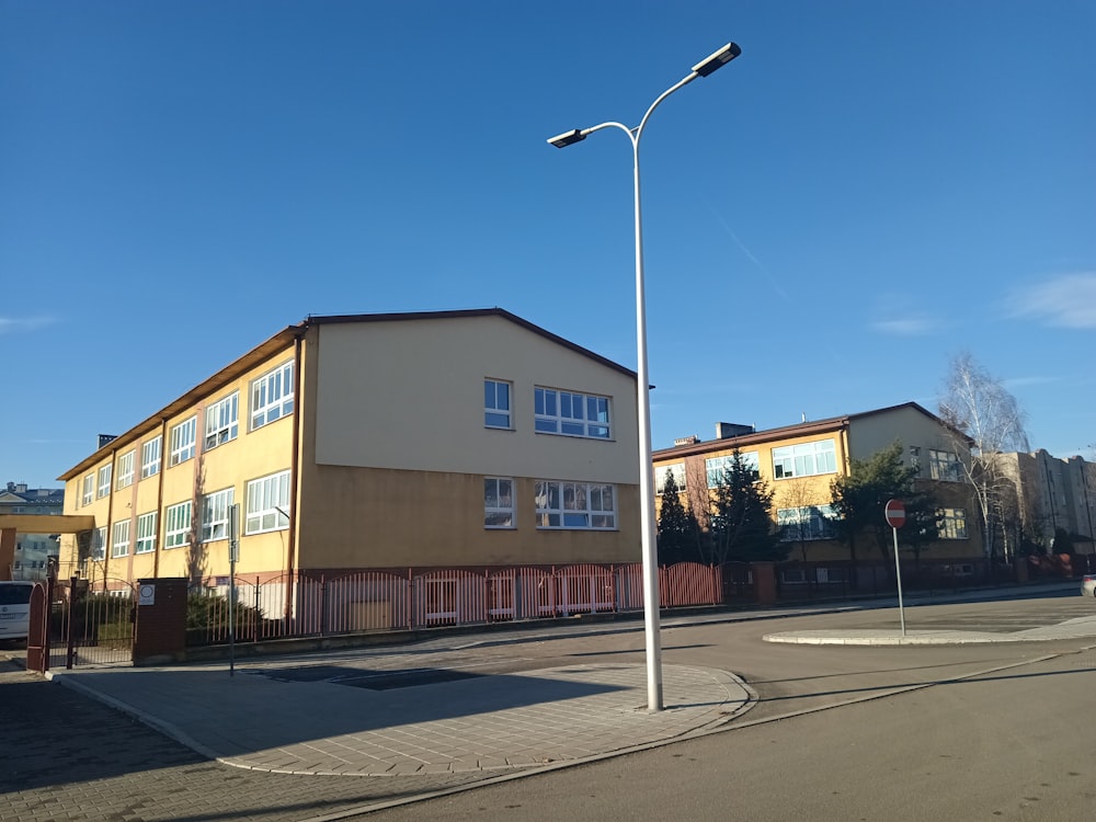 an empty street in front of a yellow building