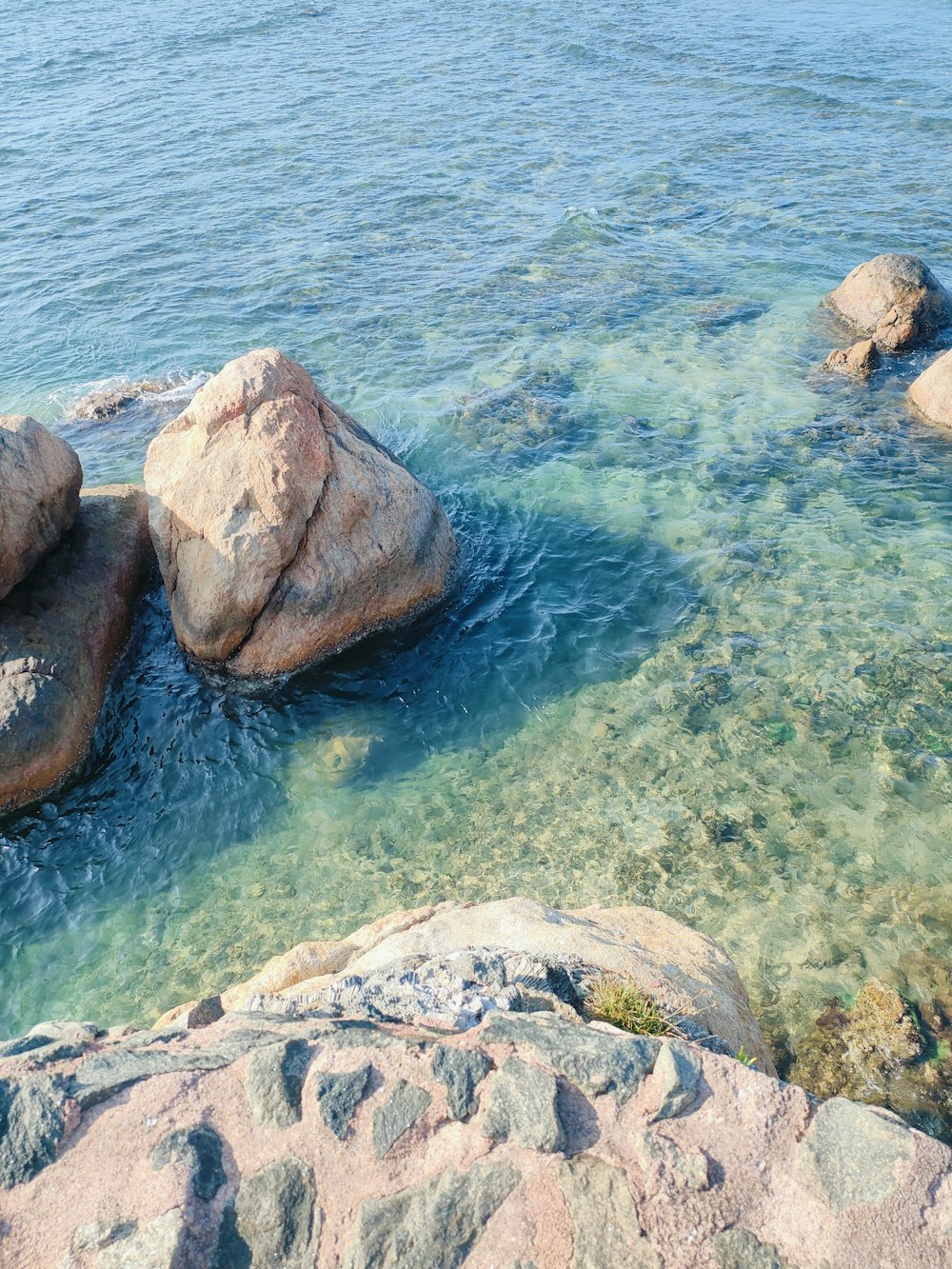 a couple of rocks sitting on top of a body of water