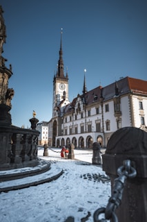 a large building with a clock tower in the background