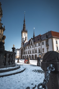 a large building with a clock tower in the background