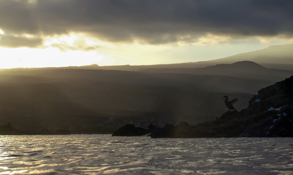 a body of water with a mountain in the background