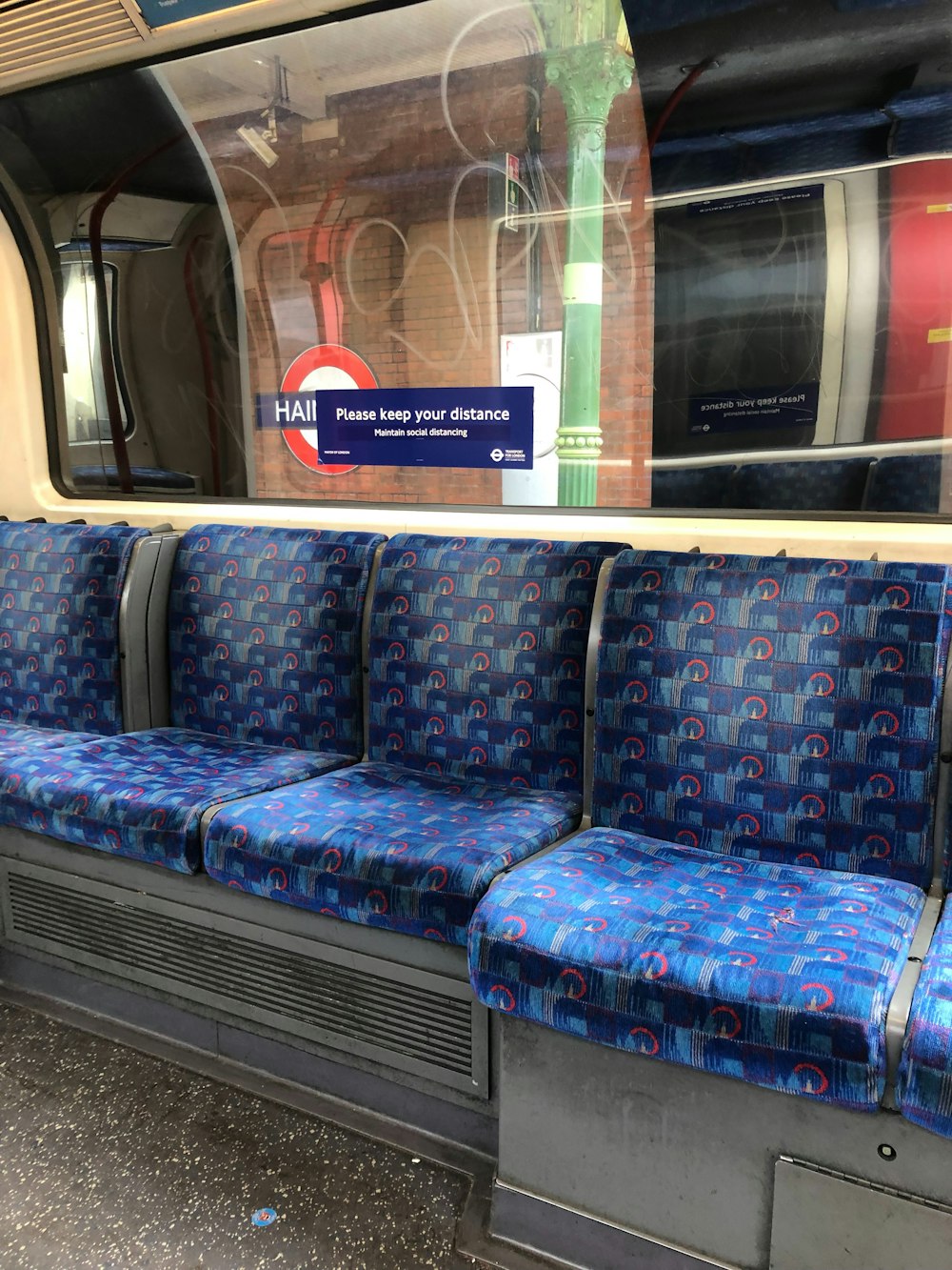a train with blue seats and a sign on the window