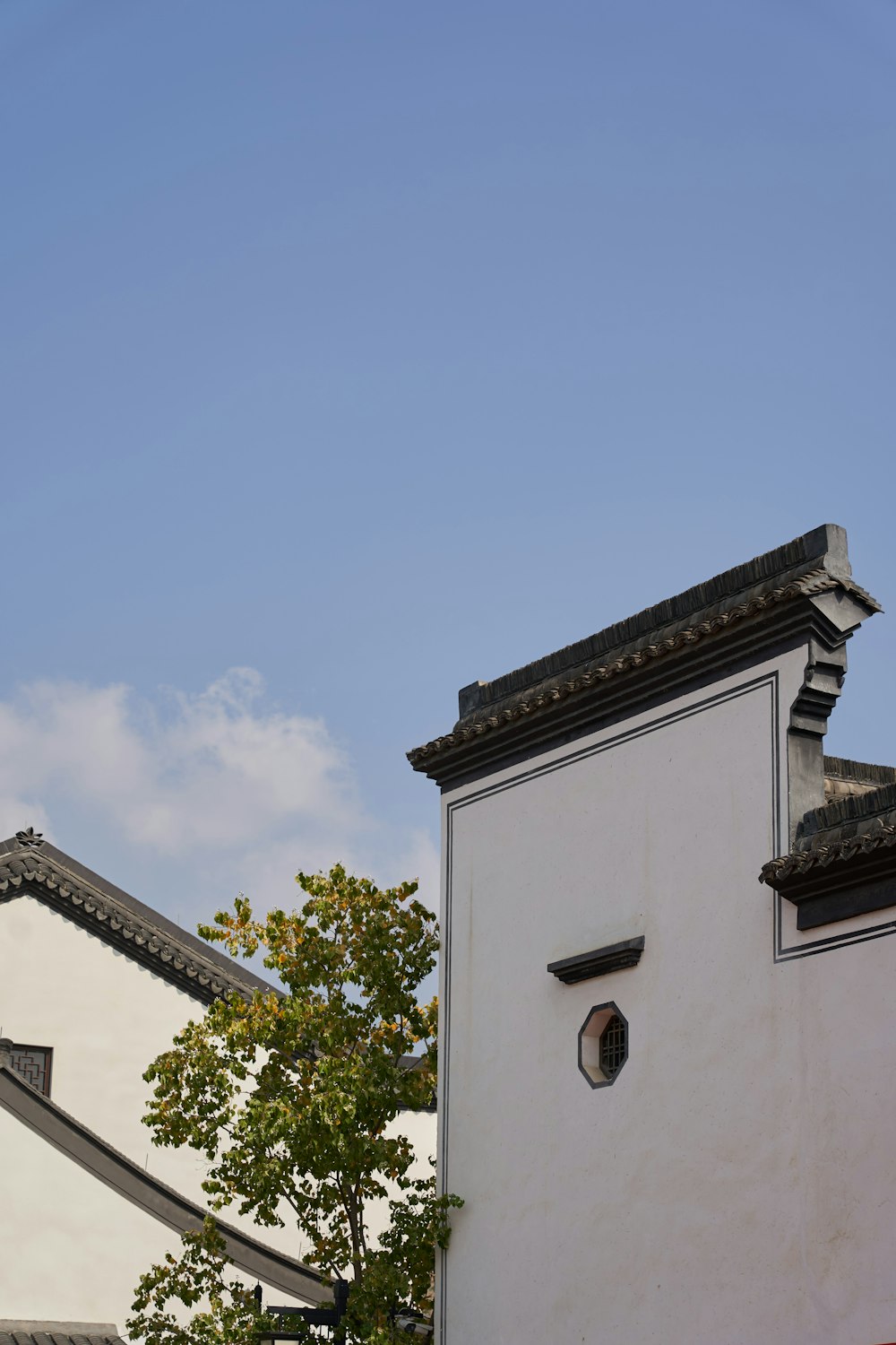 a white building with a clock on the side of it