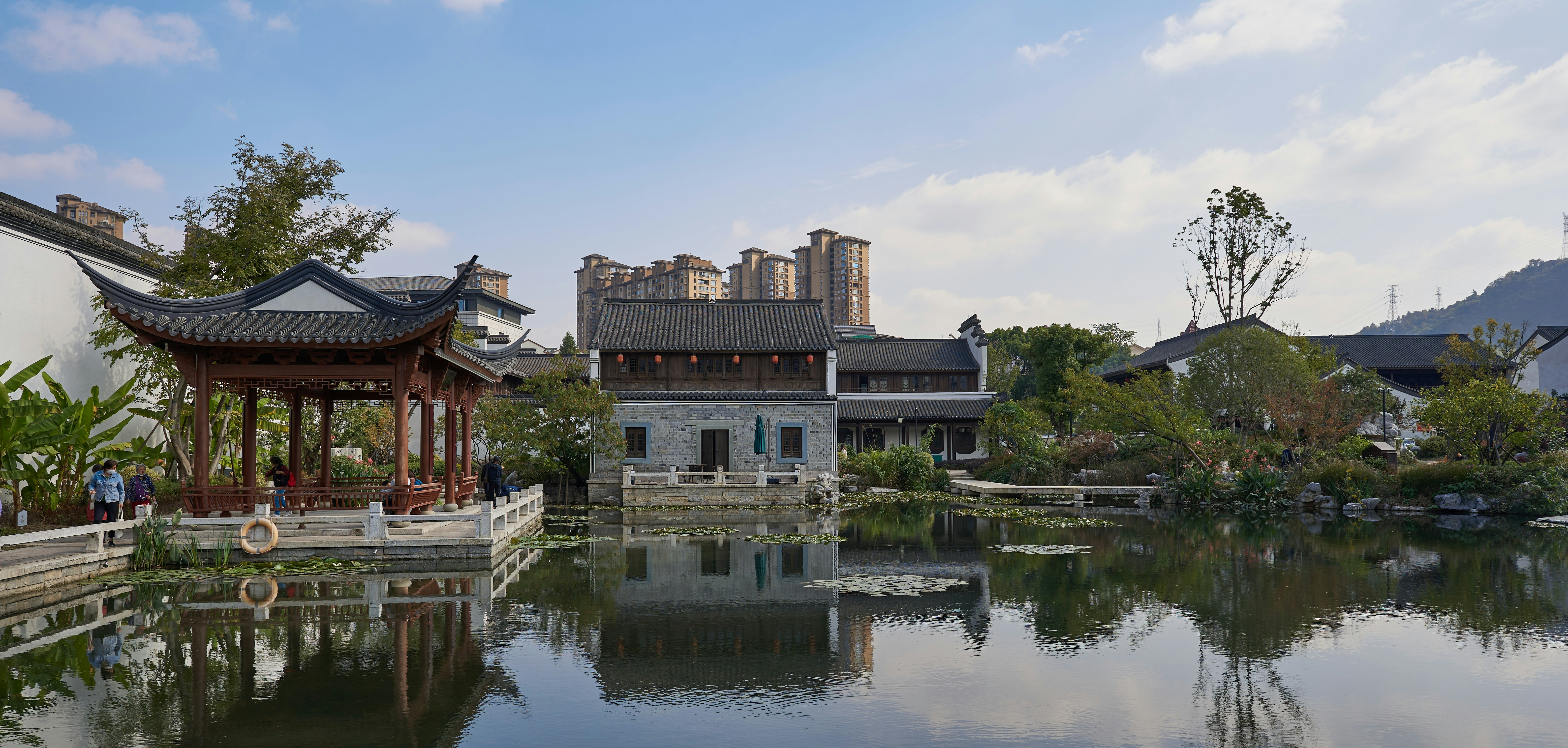 a pond with a pavilion in the middle of it