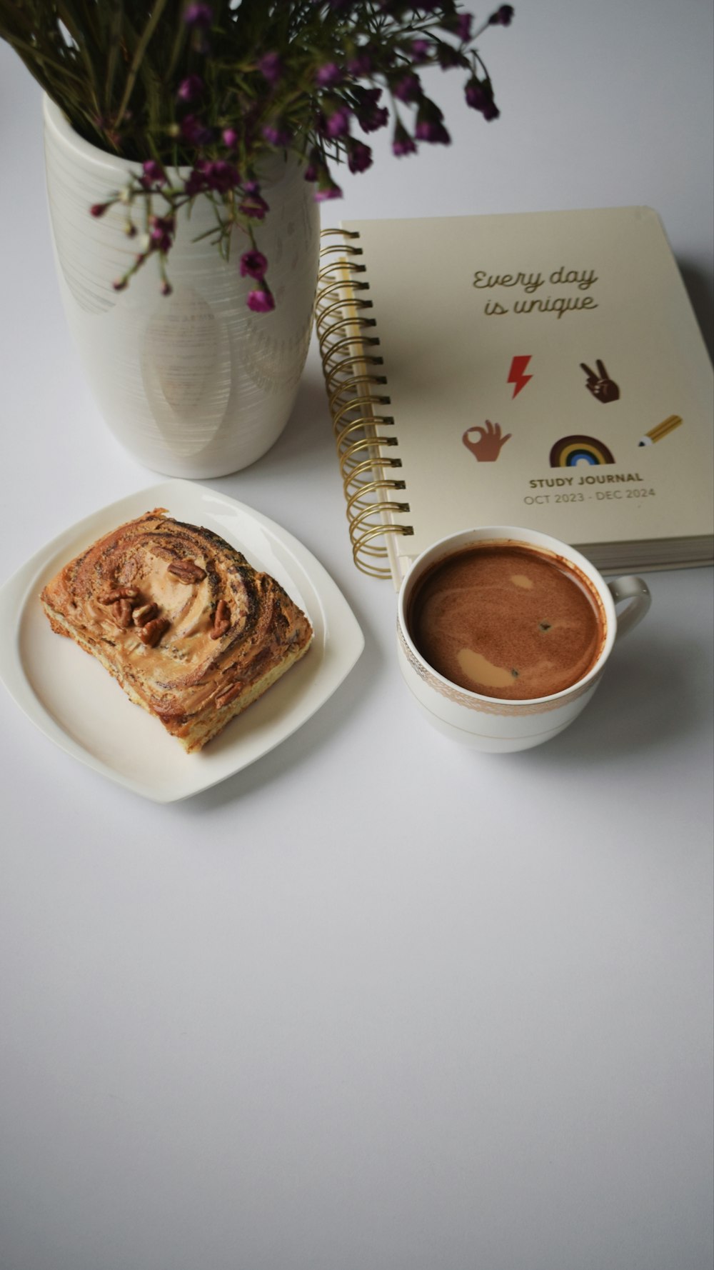 a plate of food next to a cup of coffee