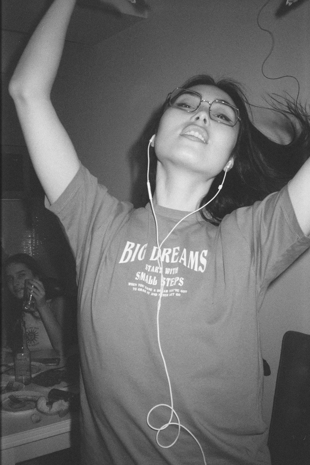 a woman wearing headphones and a big dreams t - shirt