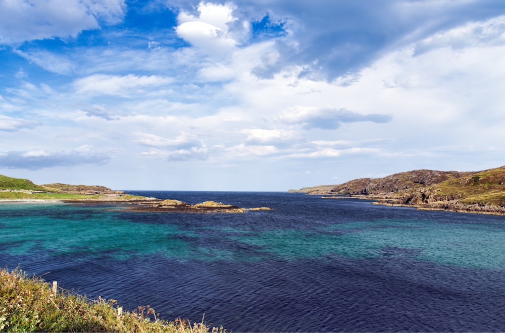 a large body of water surrounded by hills