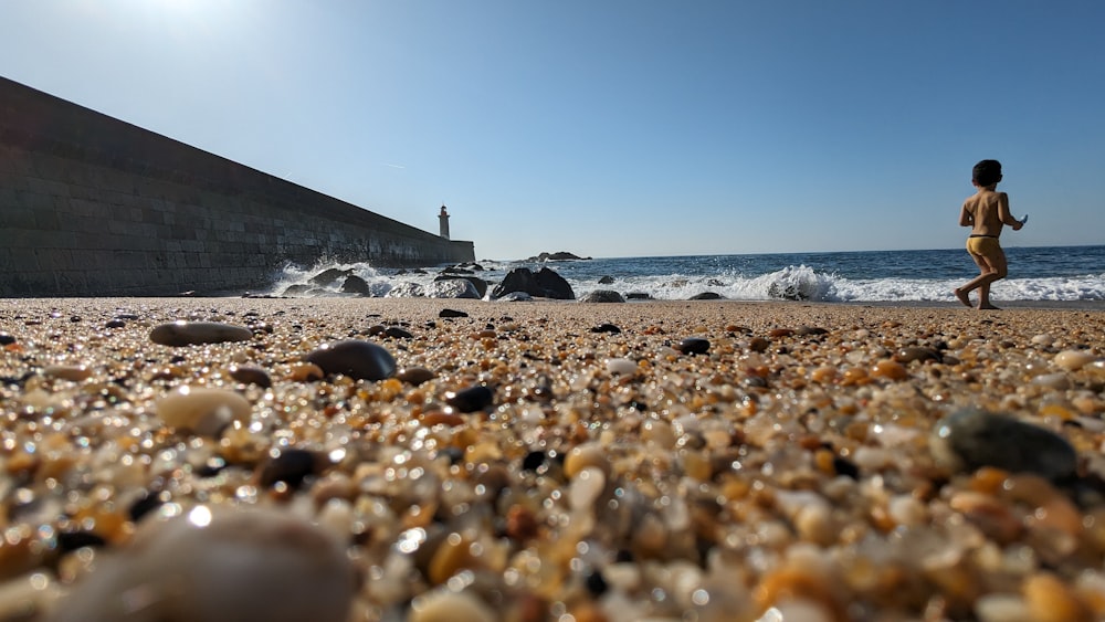 a person running on a beach near the ocean