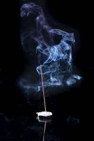 a incense stick with smoke coming out of it