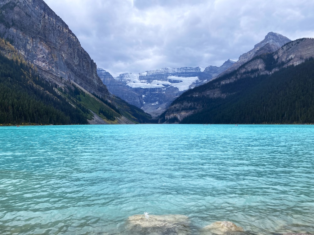 a body of water with mountains in the background