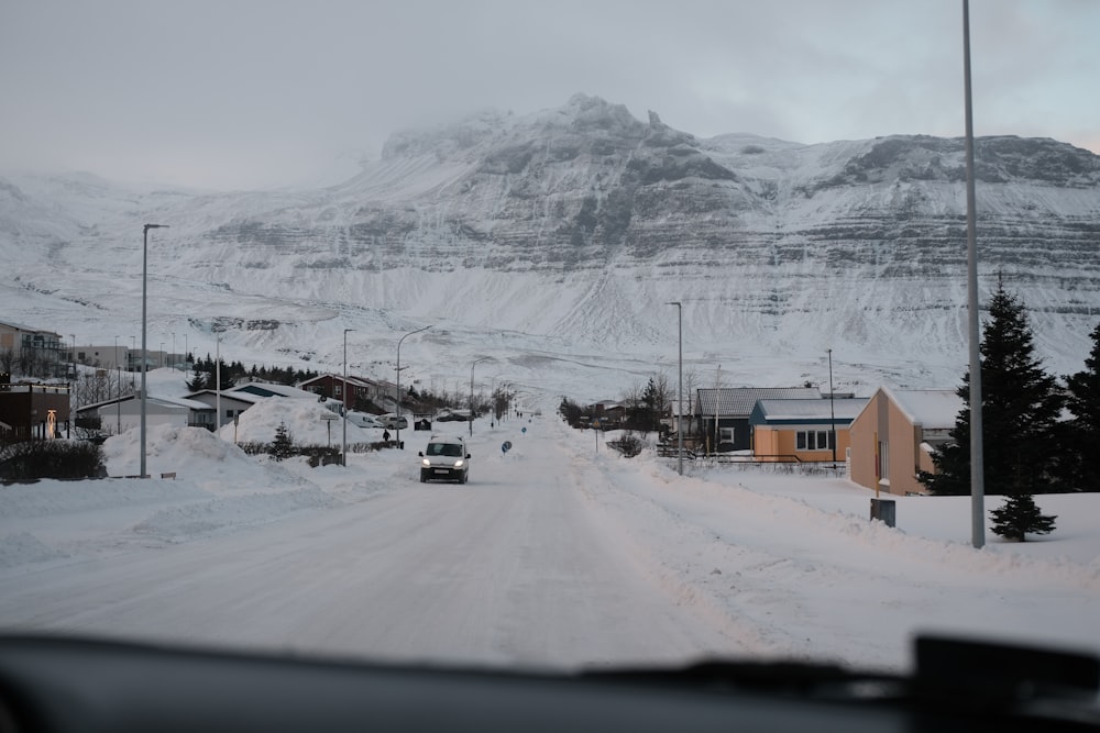 a car driving down a snow covered road