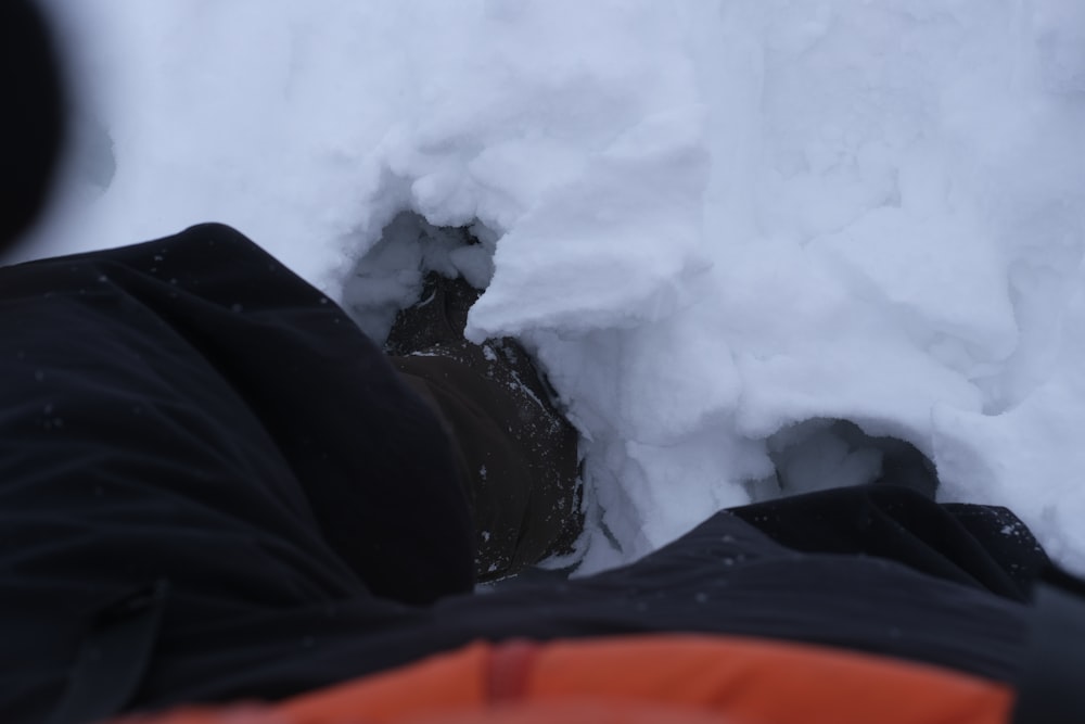 a person is laying down in the snow