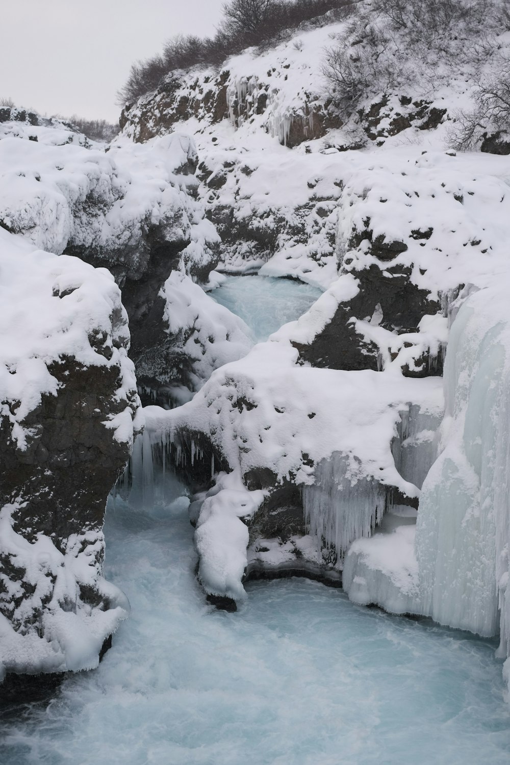 a frozen waterfall in the middle of a mountain