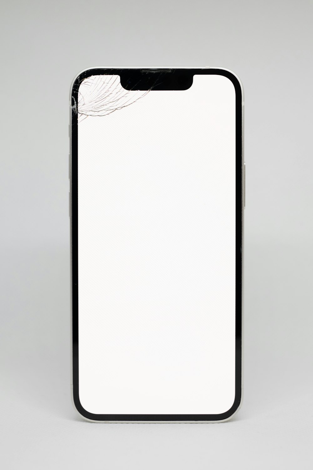 a cell phone with a broken screen on a white background