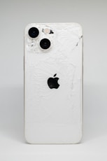 a white iphone with a cracked screen