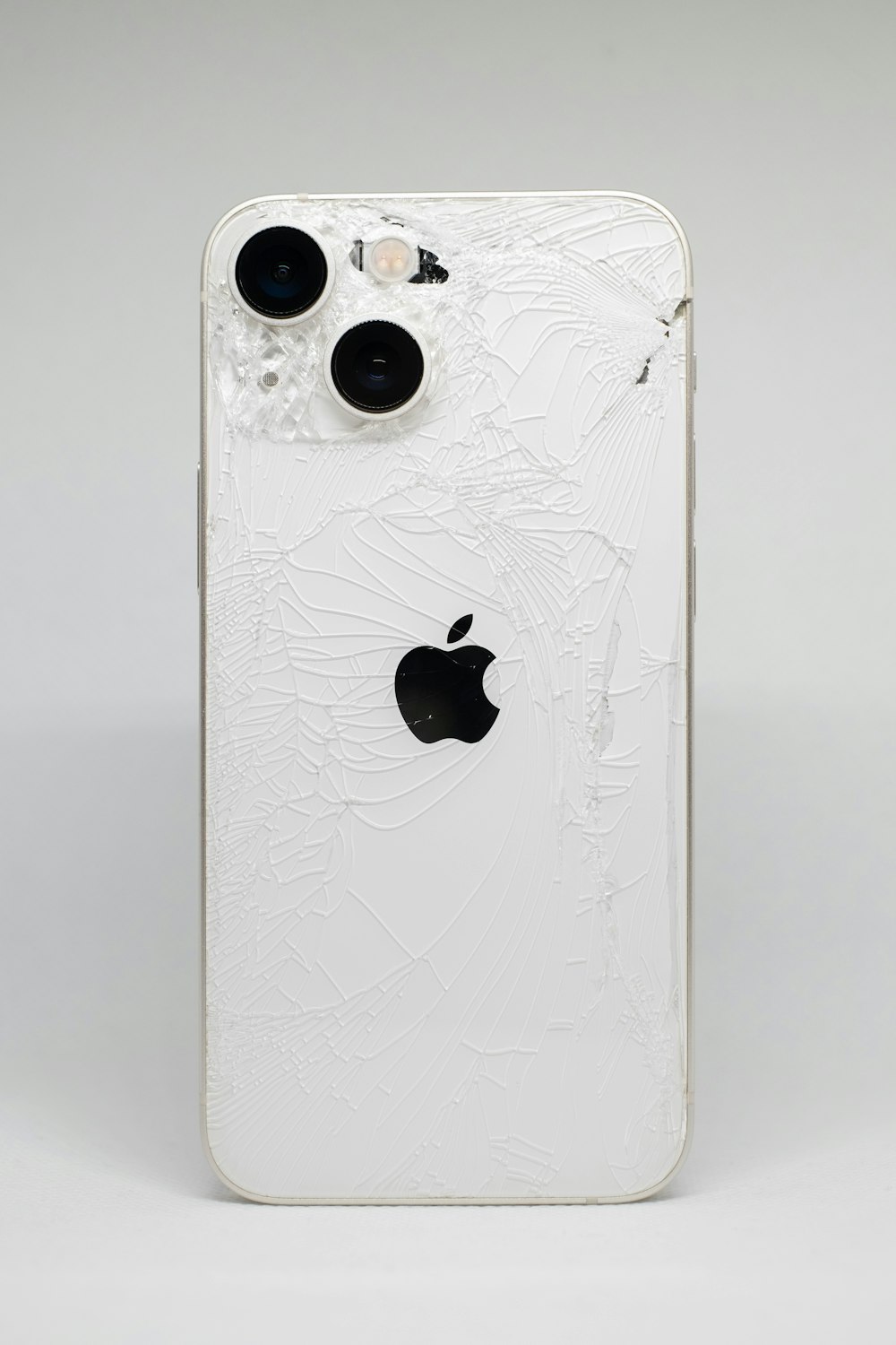 a white iphone with a cracked screen