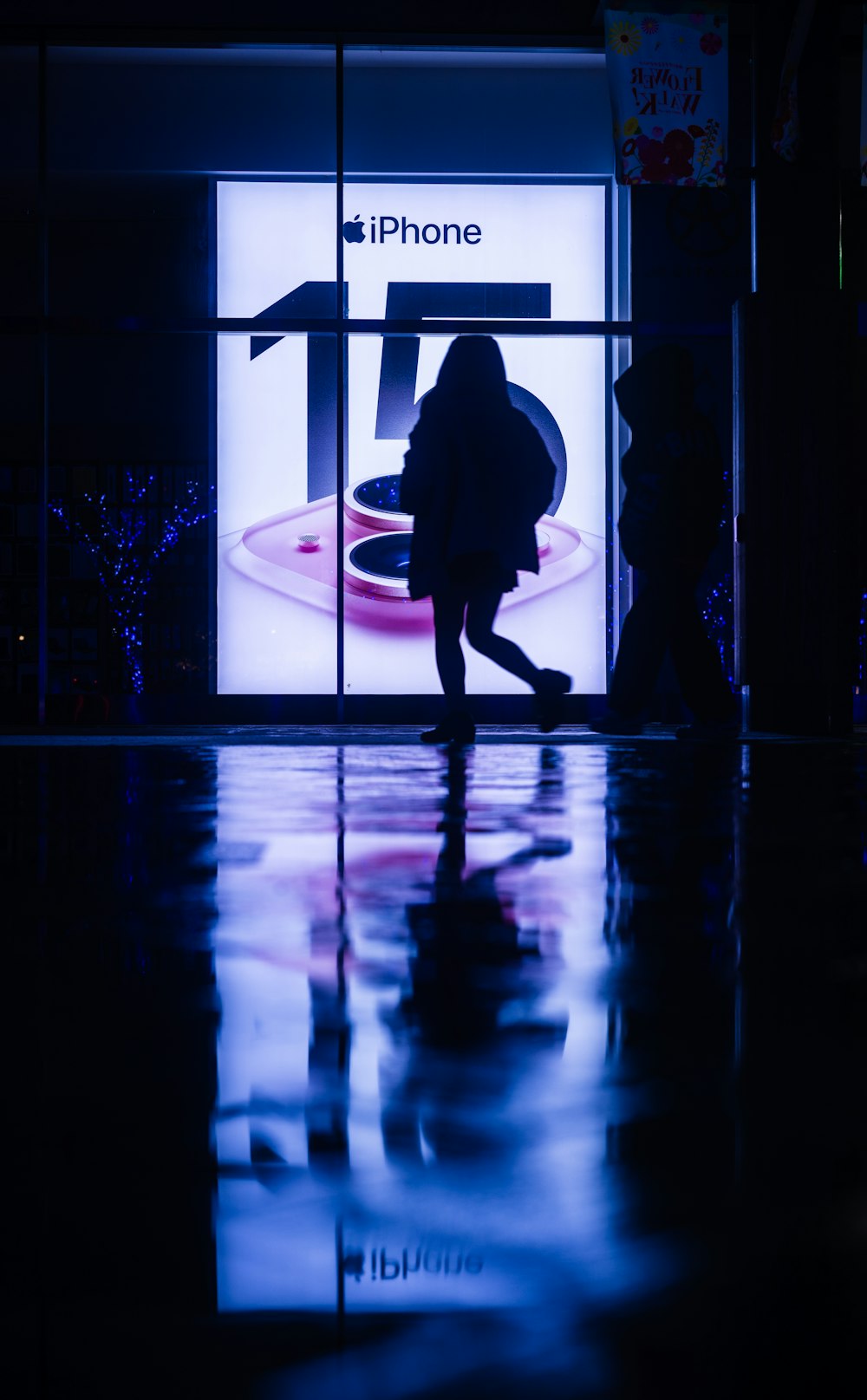 a woman is walking past a store window