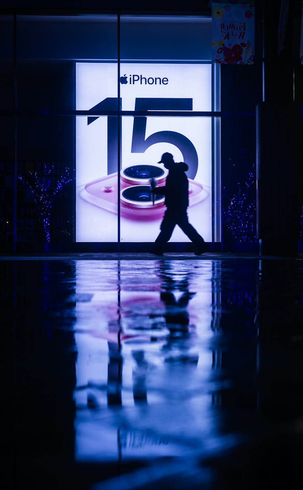 a man walking past a store front with a glass window