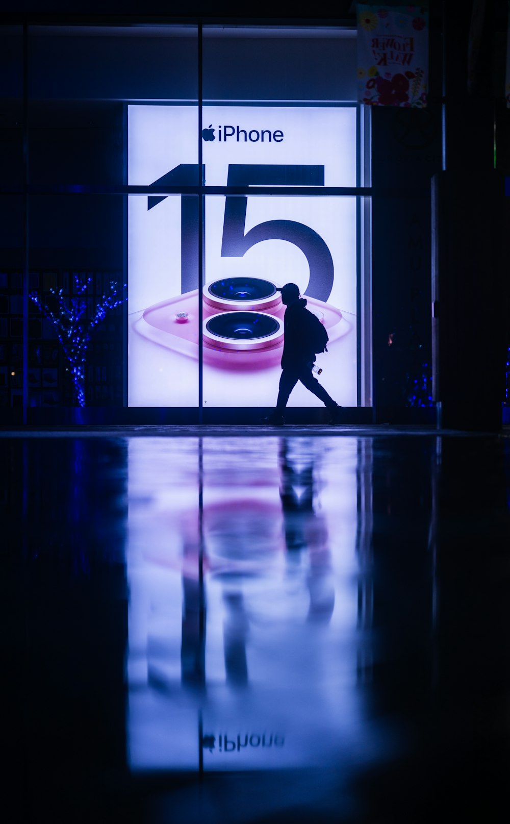 a man is walking past a store window