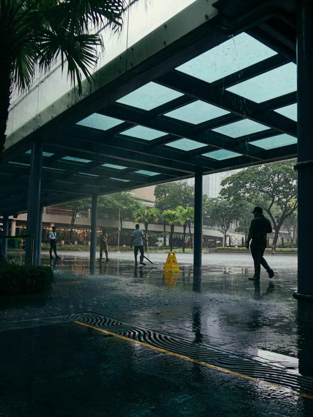 a group of people walking down a rain soaked street