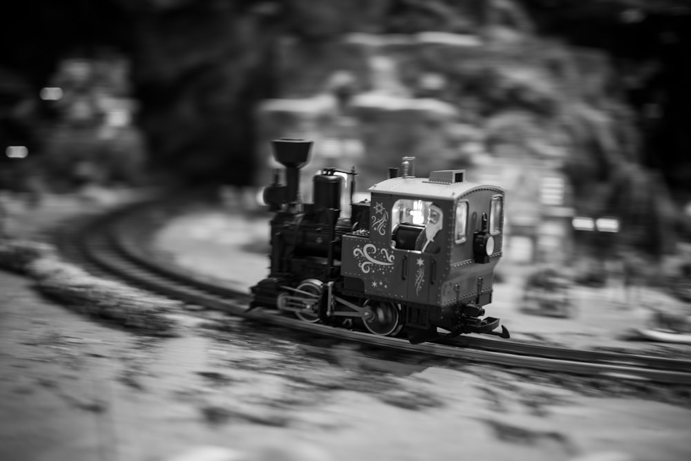 a black and white photo of a toy train