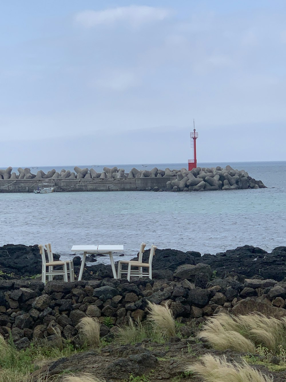 a couple of white chairs sitting next to a white table