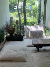 a bed with a white comforter and pillows