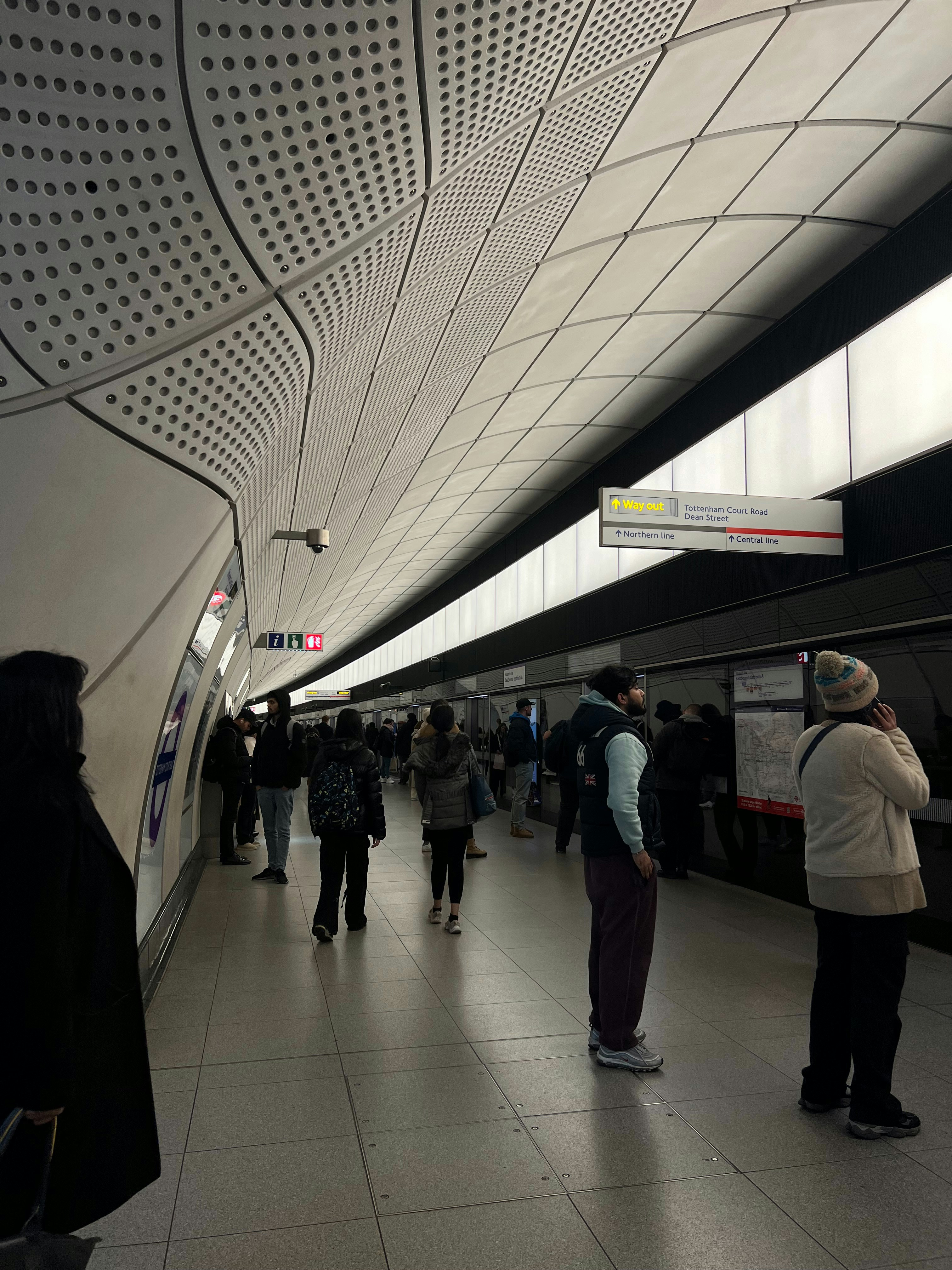 a group of people standing around a train station