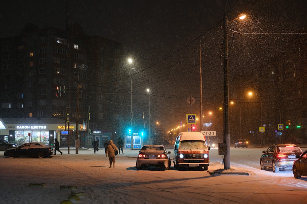 a couple of cars that are sitting in the snow