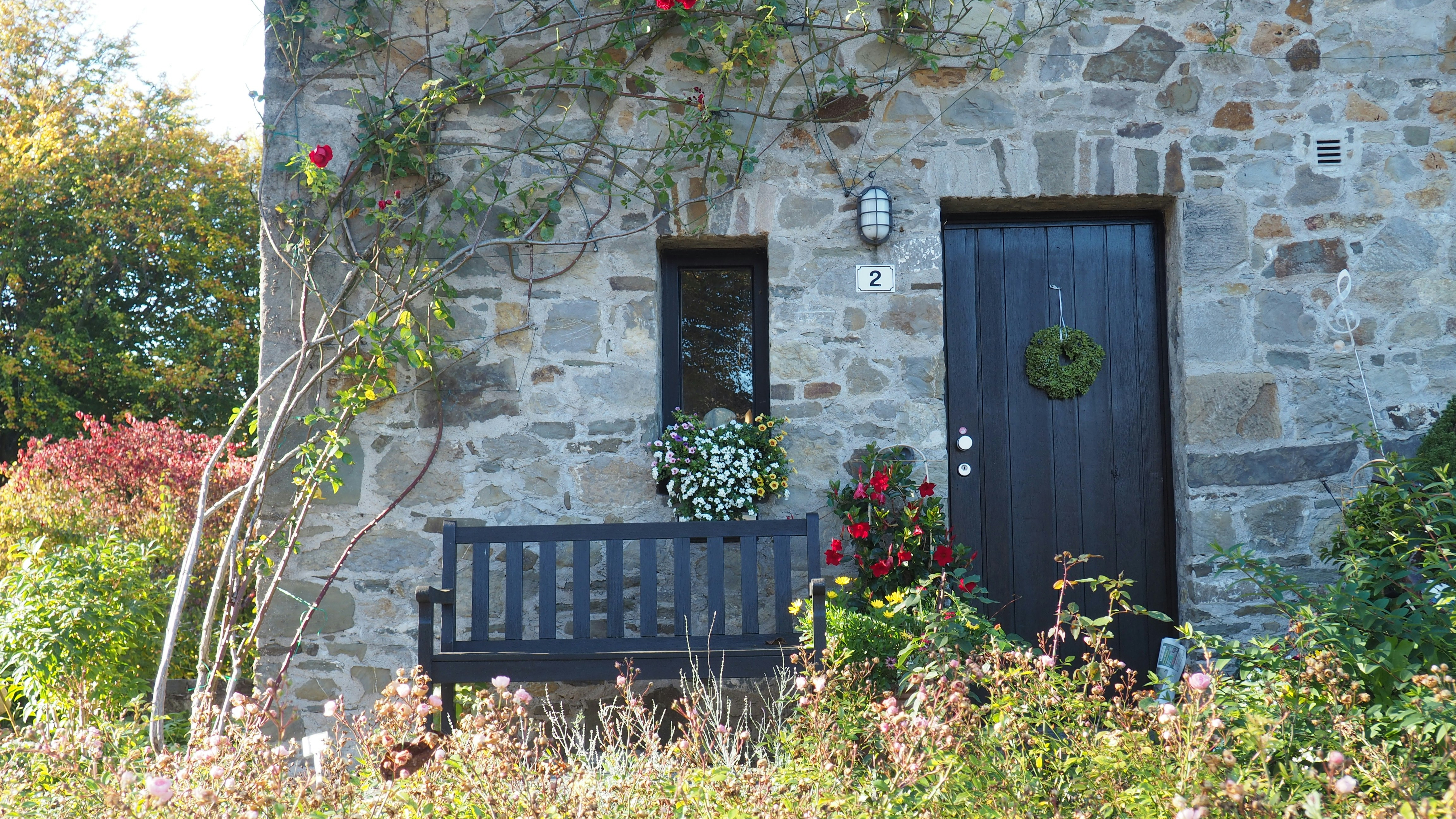 a bench sitting in front of a stone building