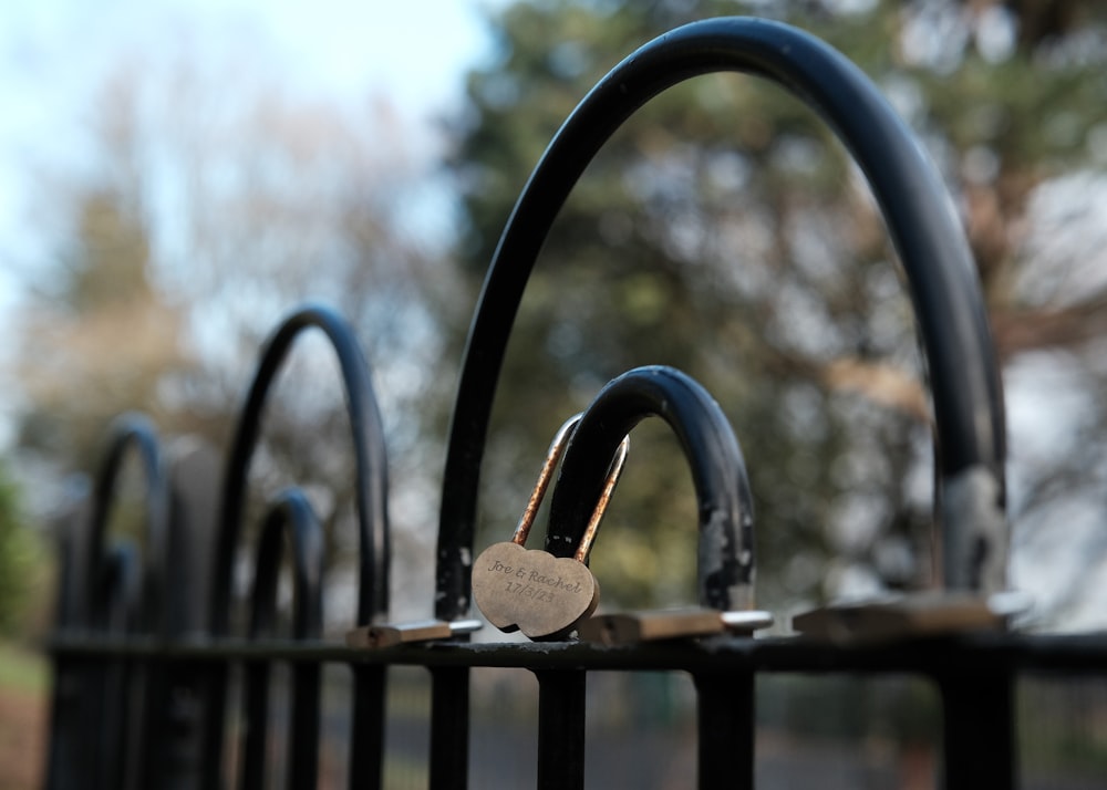 a close up of a metal fence with a padlock on it