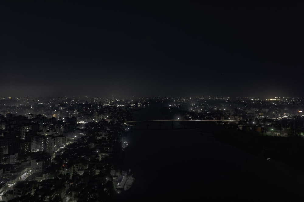 a view of a city at night from the top of a hill